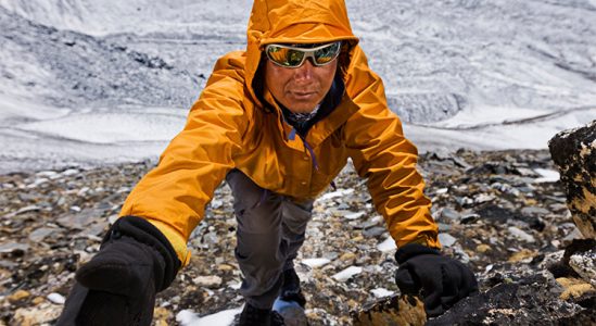 Sherpa on a cliff in Himalayas